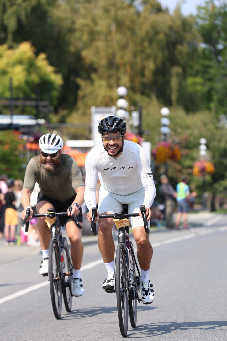 Two cyclists riding together at a cycling event